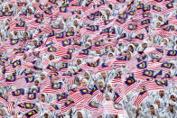 <p>Students wave the Malaysian flag during the 59th National Day celebrations at the Independence Square in Kuala Lumpur, Malaysia, Aug. 31, 2016. Malaysia gained its independence on Aug. 31, 1957. (Photo: Joshua Paul/AP)</p>