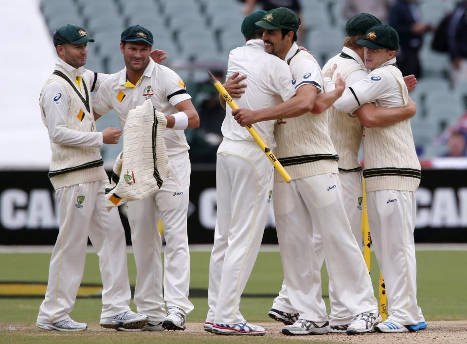 Australia's captain Michael Clarke (L) and Ryan Harris (2nd L) celebrate with team mates after winning the second Ashes cricket test against England at the Adelaide Oval December 9, 2013. Australia captured England's four remaining wickets before lunch to close out an emphatic 218-run victory in the second Ashes test on Monday. REUTERS/David Gray (AUSTRALIA - Tags: SPORT CRICKET)