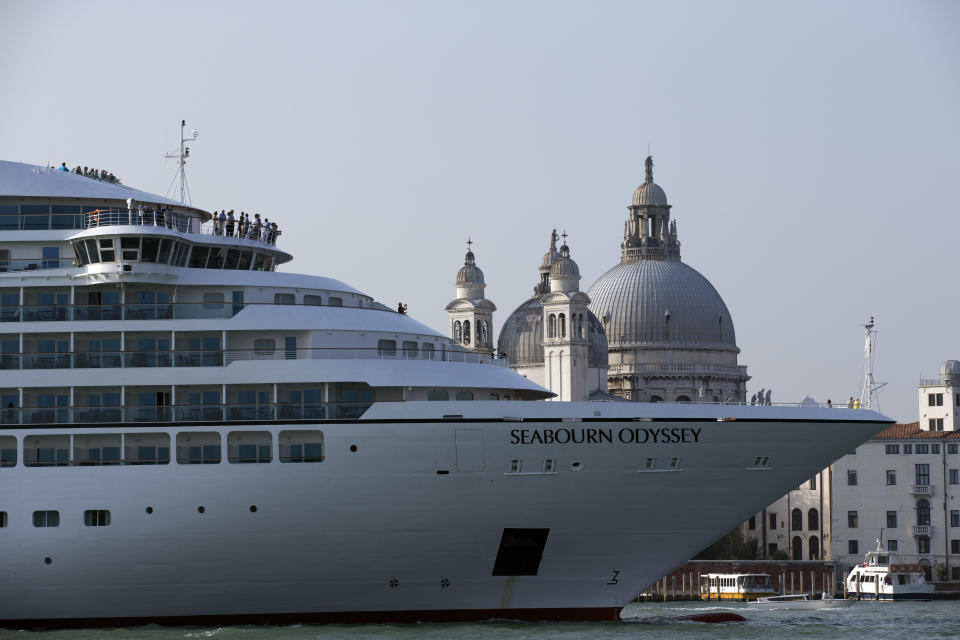 FILE-- In this Sept. 27, 2014 file photo a cruise ship transits in the Giudecca canal in front of St. Mark's Square, in Venice, Italy. Declaring Venice's waterways a “national monument,” Italy is banning mammoth cruise liners from sailing into the lagoon city, which risked within days being declared an imperiled world heritage site by the United Nations. Culture Minister Dario Franceschini said the ban will take effect on Aug. 1 and was urgently adopted at a Cabinet meeting on Tuesday. (AP Photo/Andrew Medichini)