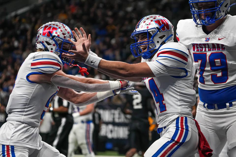 Westlake quarterback Brett Skinner (14) celebrates a touchdown run Saturday. Skinner sparked the offense off the bench.