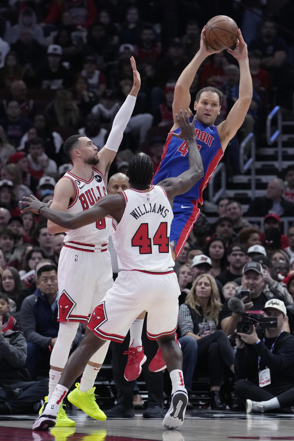 Detroit Pistons forward Bojan Bogdanovic, right, looks to pass as Chicago Bulls guard Zach LaVine, left, and forward Patrick Williams defend during the first half of an NBA basketball game in Chicago, Friday, Dec. 30, 2022. (AP Photo/Nam Y. Huh)
