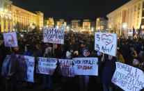 Far right activists gather at the Maidan to march to the Presidential Office where they will demand that administration officials are dismissed in Kyiv, Ukraine, Wednesday, Dec.1 2021. Activists demanded the resignation of Head of Ukraine's Presidential Office Andriy Yermak. (AP Photo/Efrem Lukatsky)