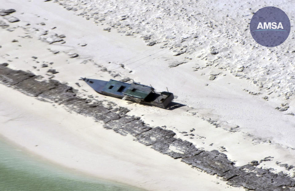 In this photo provided by the Australian Maritime Safety Authority, a fishing boat is beached on Bedwell Island, 313 km (194 miles) west of Broome, Australia, on Monday, April 17, 2023. Nine Indonesian fishermen are feared dead and another 11 have been rescued after spending six days without food or water on a barren island off the northwest Australian coast in the aftermath of a powerful tropical cyclone, authorities said on Wednesday, April 19, 2023. (Australian Maritime Safety Authority via AP)