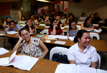 Filipino workers, including nurses applying to work in United Kingdom, attend a lecture at a review center for the International English Language Testing System or IELTS in Manila, Philippines, April 2, 2019. Picture taken April 2, 2019. REUTERS/Eloisa Lopez