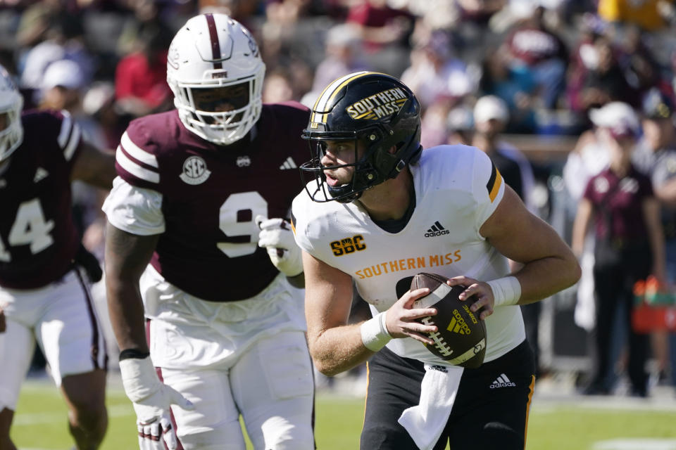 Southern Mississippi quarterback Billy Wiles (8) is pursued by Mississippi State defensive end De'Monte Russell (9) during the first half of an NCAA college football game in Starkville, Miss., Saturday, Nov. 18, 2023. (AP Photo/Rogelio V. Solis)