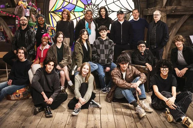 <p>Helen Sloan/Netflix</p> (L-R) Georgie Farmer, Victor Dorobantu, Luyanda Unati Lewis-Nayo, Joy Sunday, Owen Painter, Emma Myers, Billie Piper, Jenna Ortega, Evie Templeton, Luis Guzmán, Isaac Ordonez, Catherine Zeta-Jones, Alfred Gough, Noah Taylor, Miles Millar, Tim Burton, Steve Buscemi, Moosa Mostafa, Hunter Doohan on the set of 'Wednesday' season 2.