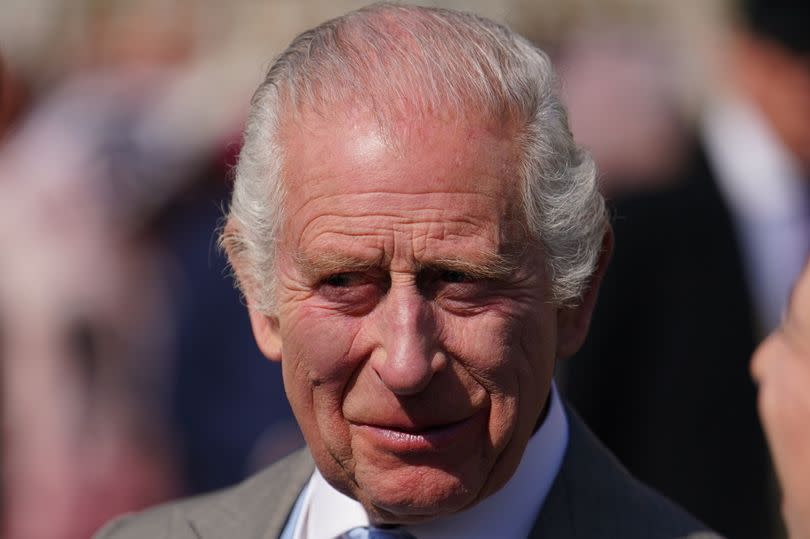 King Charles III speaks to guests attending a Royal Garden Party