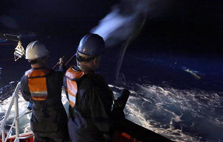 Steve March (L) and Mike Unzicker recover the Phoenix International Autonomous Underwater Vehicle (AUV) Artemis, also known as the Bluefin-21, back onto the Australian Defence Vessel Ocean Shield after searching for missing Malaysia Airlines Flight MH370 in the Southern Indian Ocean in this undated picture released on April 21, 2014 by the Australian Defence Force. REUTERS/Australian Defence Force/Handout via Reuters