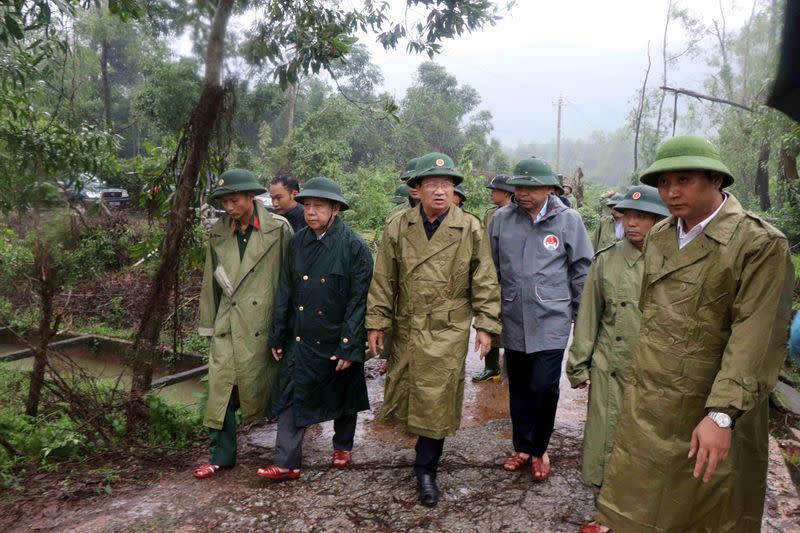 Vietnam's Deputy Prime Minister Trinh Dinh Dung (C) leads a rescue team to search for missing people at a site of a landslide near a hydropower dam in Thua Thien Hue province