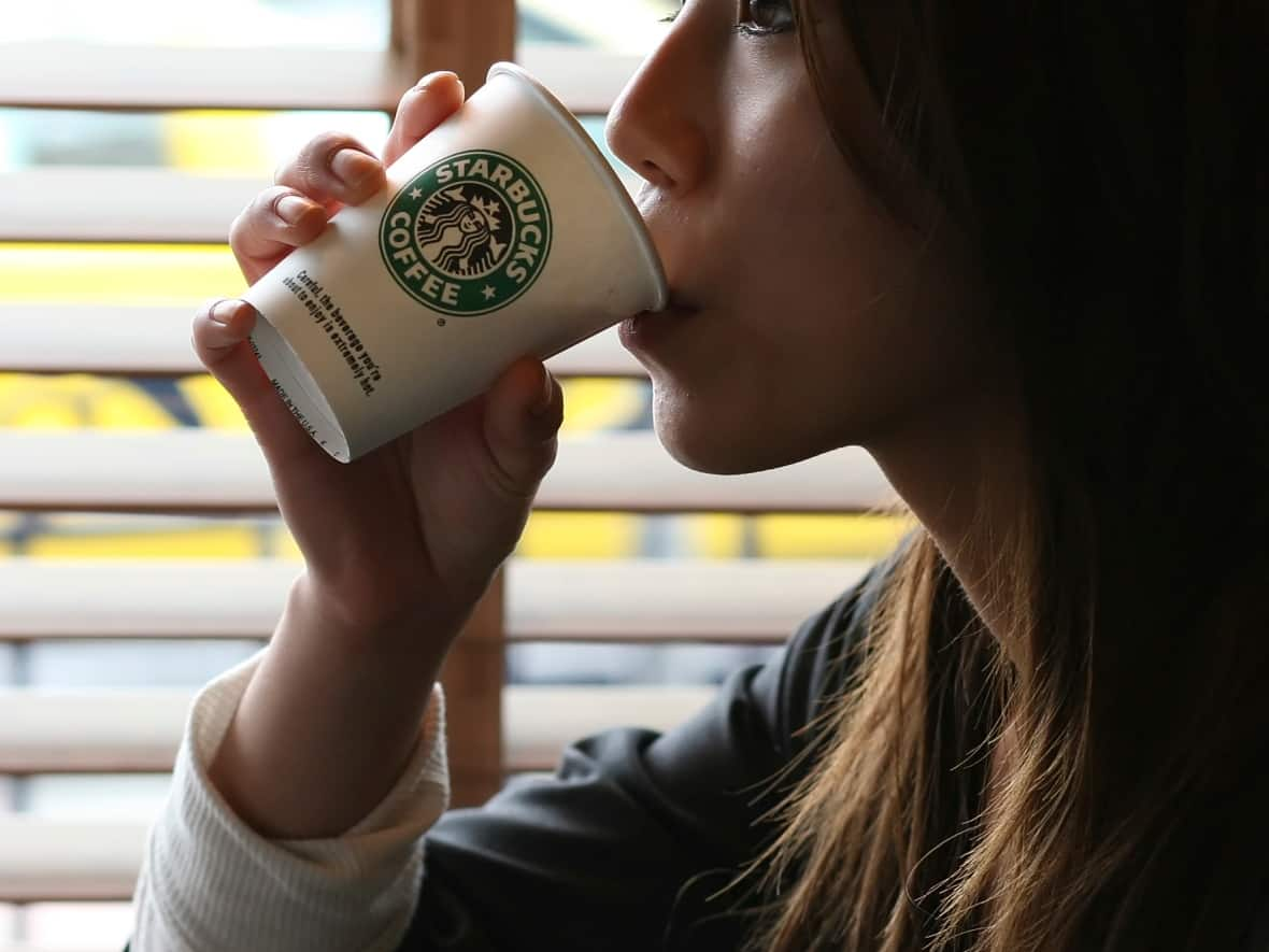 As of Monday, Starbucks drinkers like this woman in a location in Seattle will need to spend twice as many reward points to get a cup of coffee. (Marcus Donner/Reuters - image credit)