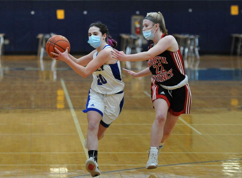 Quincy's Mary Saccoach, left, keeps the ball away from  North Quincy's Molly Toland  during girls basketball action at Quincy High School, Tuesday, Jan. 19, 2021.