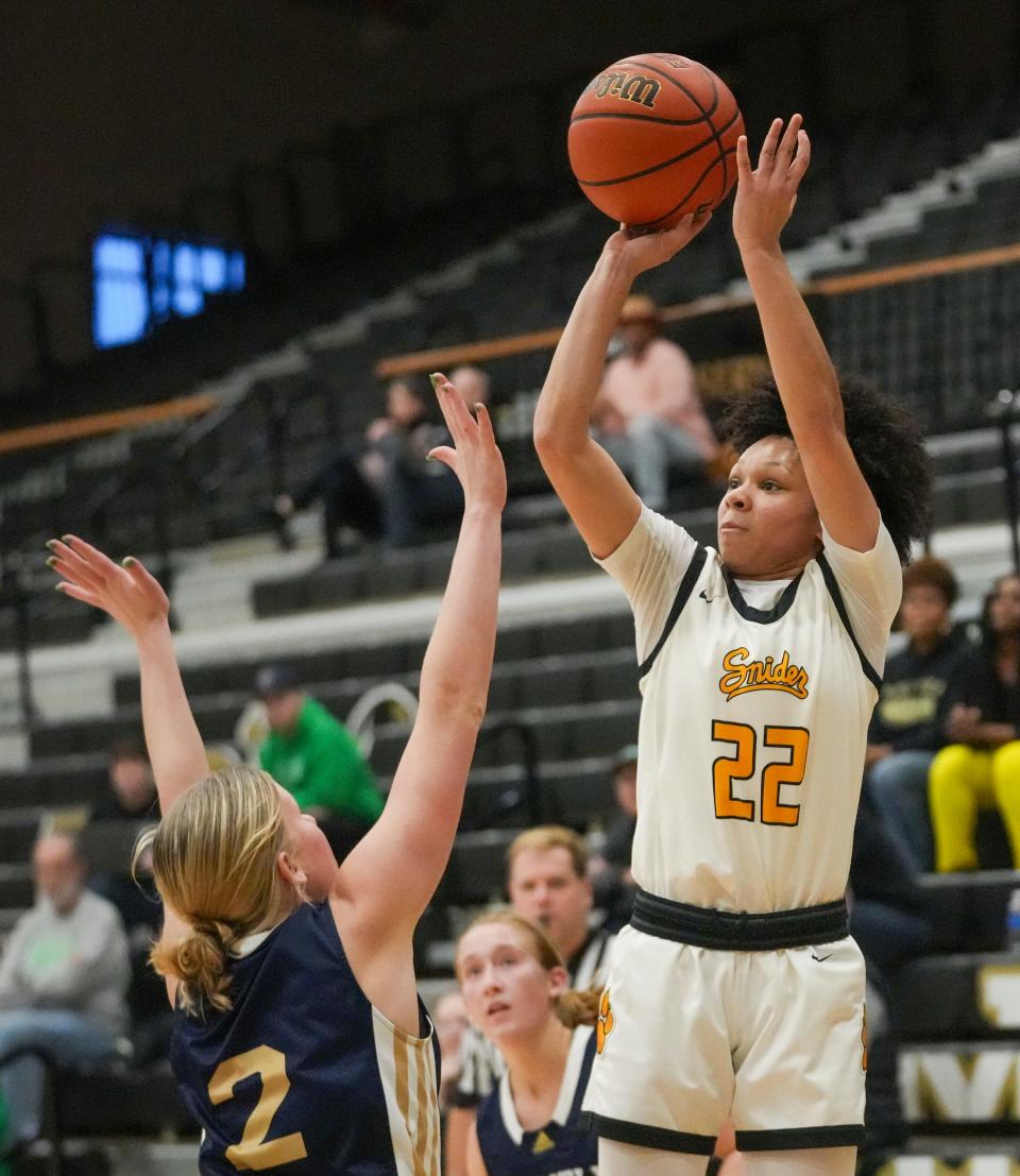 Fort Wayne Snider High School's Jordyn Poole (22) shoots against Norwell High School's Addison Norris at Noblesville High School, Dec 28, 2023. Ft. Wayne Snyder won 65-50.