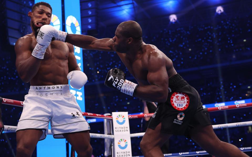 Daniel Dubois punches Anthony Joshua during the first round of their fight at Wembley