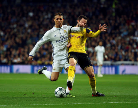 Football Soccer - Real Madrid v Borussia Dortmund - UEFA Champions League Group Stage - Group F - Santiago Bernabeu stadium, Madrid, Spain - 7/12/16 Real Madrid's Cristiano Ronaldo and Borussia Dortmund's Gonzalo Castro in action. REUTERS/Susana Vera