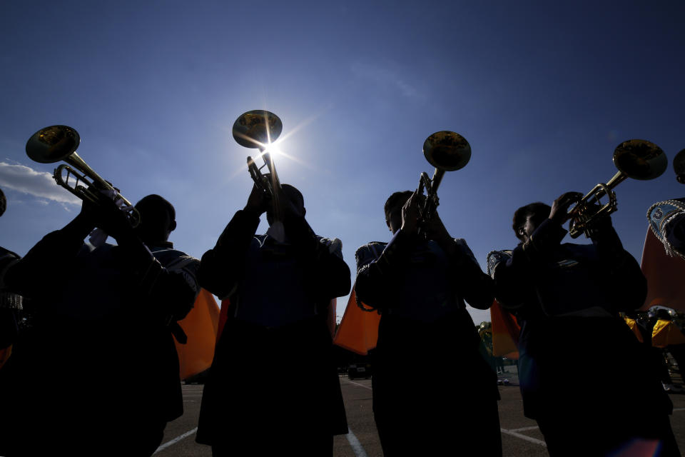 The Southern University Human Jukebox marching band trumpet section warms up in the parking lot by their buses before the 2023 National Battle of the Bands, a showcase for HBCU marching bands, held at NRG Stadium, Saturday, Aug. 26, 2023, in Houston. (AP Photo/Michael Wyke)