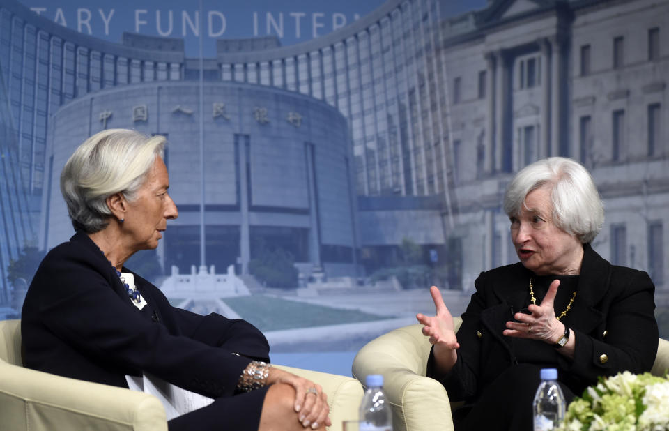 FILE - In this July 2, 2014, file photo International Monetary Fund Managing (IMF) Director Christine Lagarde, left, and Federal Reserve Chair Janet Yellen sit down for a conversation at the IMF in Washington. (AP Photo/Susan Walsh, File)