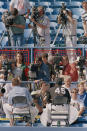 Michael Jordan sits on the top of the first-base dugout and answers reporters questions after his two-hour workout, Tuesday, Feb 15, 1994 at the Chicago White Sox spring training camp in Sarasota, Fla. Jordan took batting practice, shagged fly balls and ran the bases in front of more than 250 media representatives. (AP Photo/John Swart)