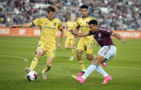 Real Salt Lake midfielder Bode Hidalgo, left, stops a kick by Colorado Rapids forward Jonathan Lewis, right, as Real Salt Lake forward Bertin Jacquesson, back, trails the play in the first half of an MLS soccer match, Saturday, May 20, 2023, in Commerce City, Colo. (AP Photo/David Zalubowski)