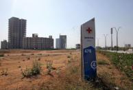 A signboard is pictured in front of buildings under construction at the Gujarat International Finance Tec-City (GIFT) at Gandhinagar, Gujarat, March 18, 2019. REUTERS/Amit Dave