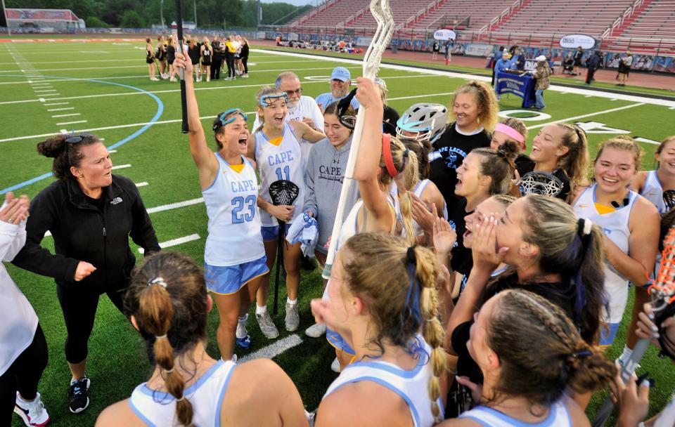 Cape Henlopen's girls Lacrosse team celebrates midfield after defeating Tatnall 16-4 for the state title.