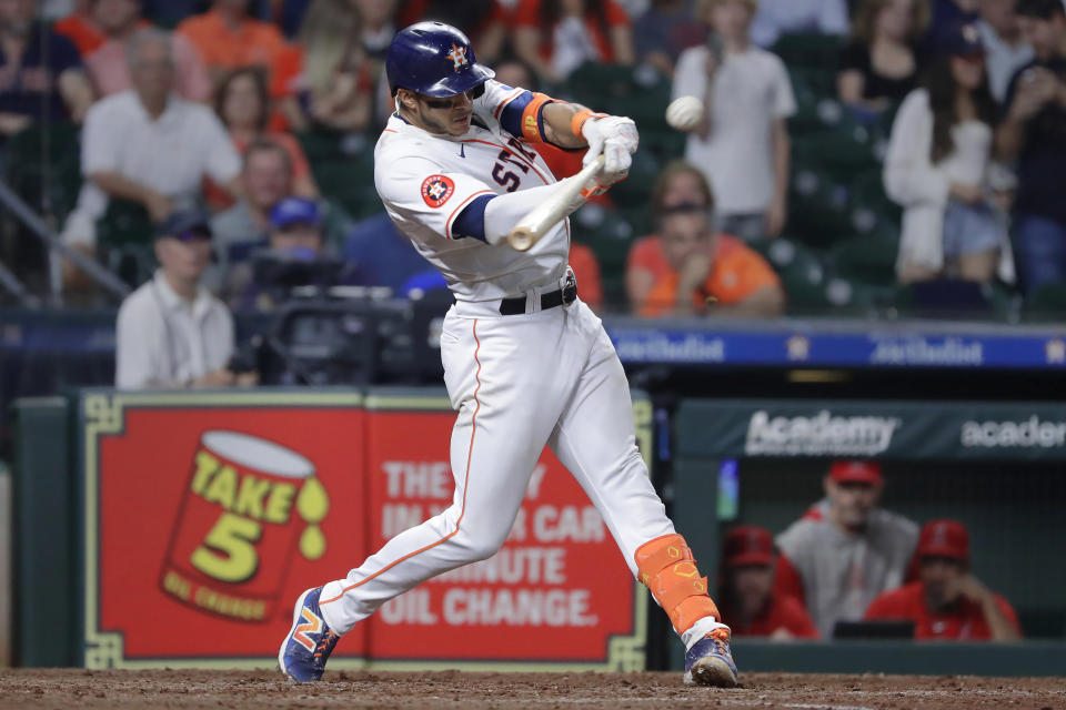 Houston Astros' Jeremy Peña hits a single to drive in the winning run against the Los Angeles Angels during the 10th inning of a baseball game Tuesday, May 21, 2024, in Houston. (AP Photo/Michael Wyke)