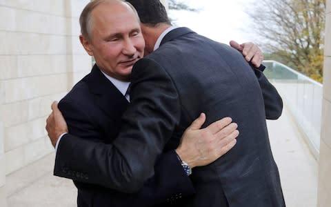 Vladimir Putin and Bashar al-Assad hug in Sochi in November. - Credit: Mikhail Klimentyev/Kremlin Pool Photo via AP