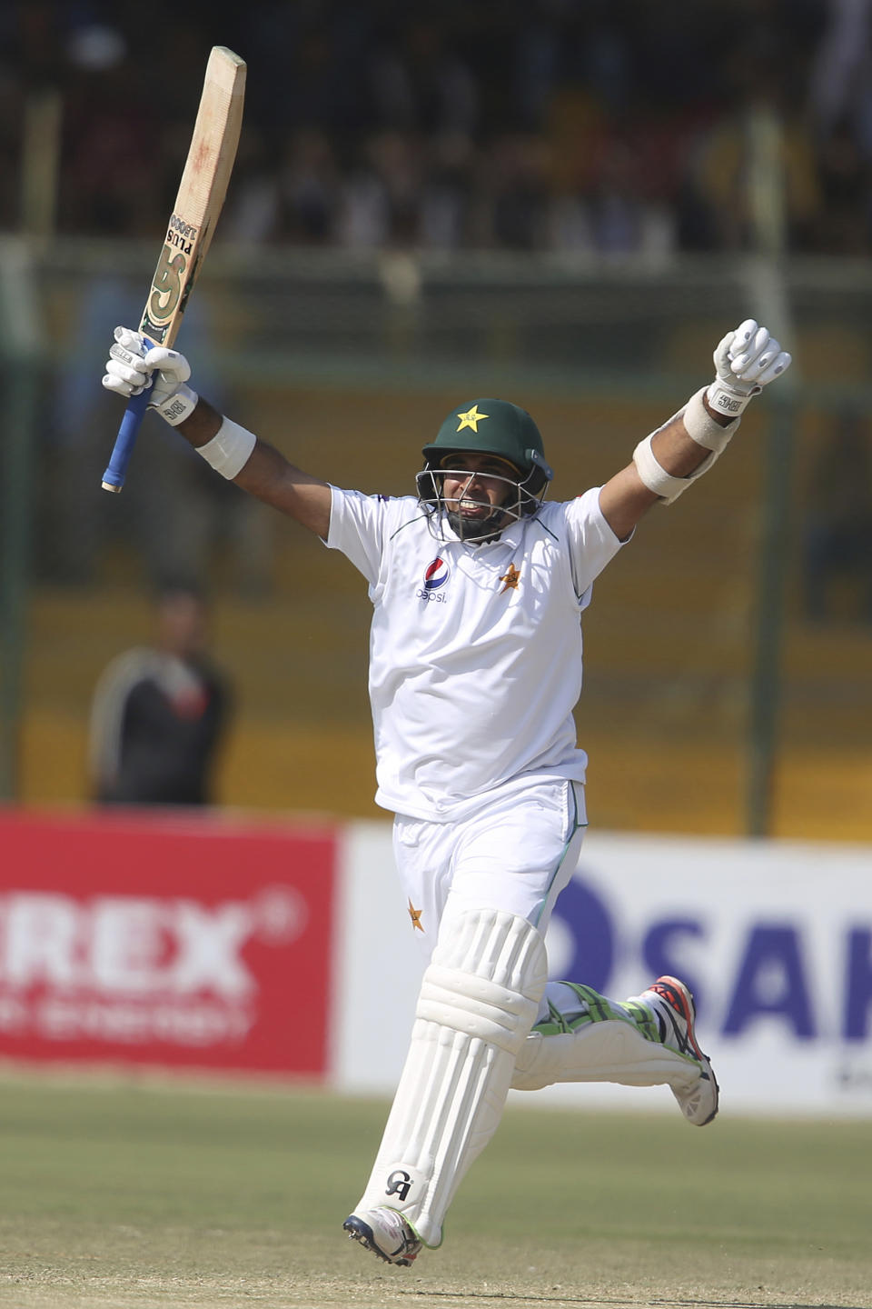 Pakistan's Abid Ali celebrates his centuary against Sri Lanka during the third day of their second Test cricket match at National Stadium in Karachi, Pakistan, Saturday, Dec. 21, 2019. (AP Photo/Fareed Khan)