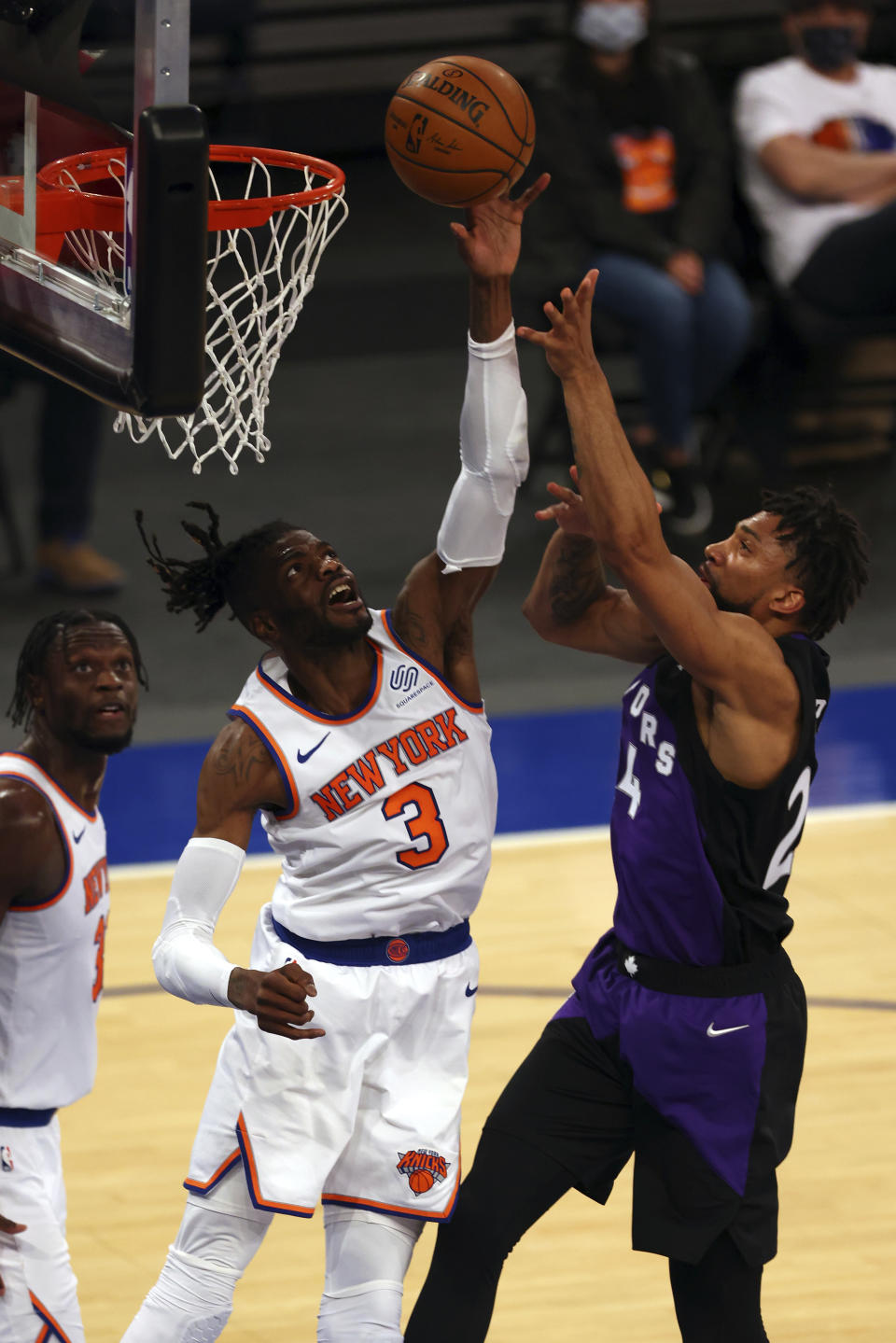 New York Knicks' Nerlens Noel (3) attempts to block a shot by Toronto Raptors' Khem Birch during an NBA basketball game at Madison Square Garden, Sunday, April 11, 2021, in New York. (Rich Schultz/Pool Photo via AP)