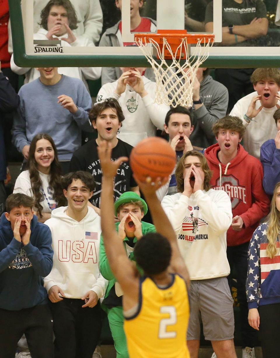 St. Vincent-St. Mary students try to distract Cleveland St. Ignatius' Carter Jackson as he shoots a foul shot against the Irish on Thursday night at LeBron James Arena. The Irish won the game 56-38. [Phil Masturzo/Beacon Journal]