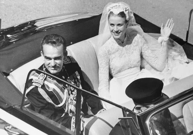 <p>Bettmann</p> Grace Kelly while returning to the palace after the religious wedding with Prince Rainier on April 20, 1956.