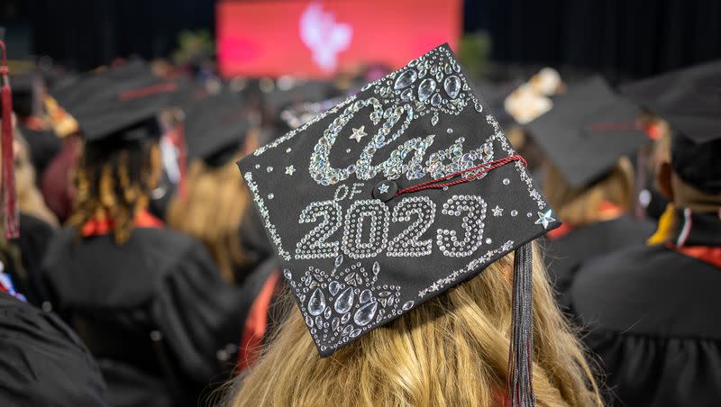 A University of Phoenix graduate looks out over the crowd during the April 29, 2023, commencement ceremony at Chase Field in Glendale, Ariz.