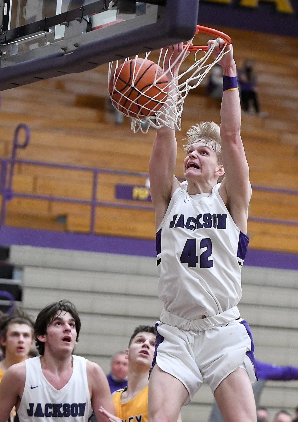 Owen Woolbert of Jackson dunks on Copley late in the fourth quarter as teammate Jovan Jovicic watches at Jackson.