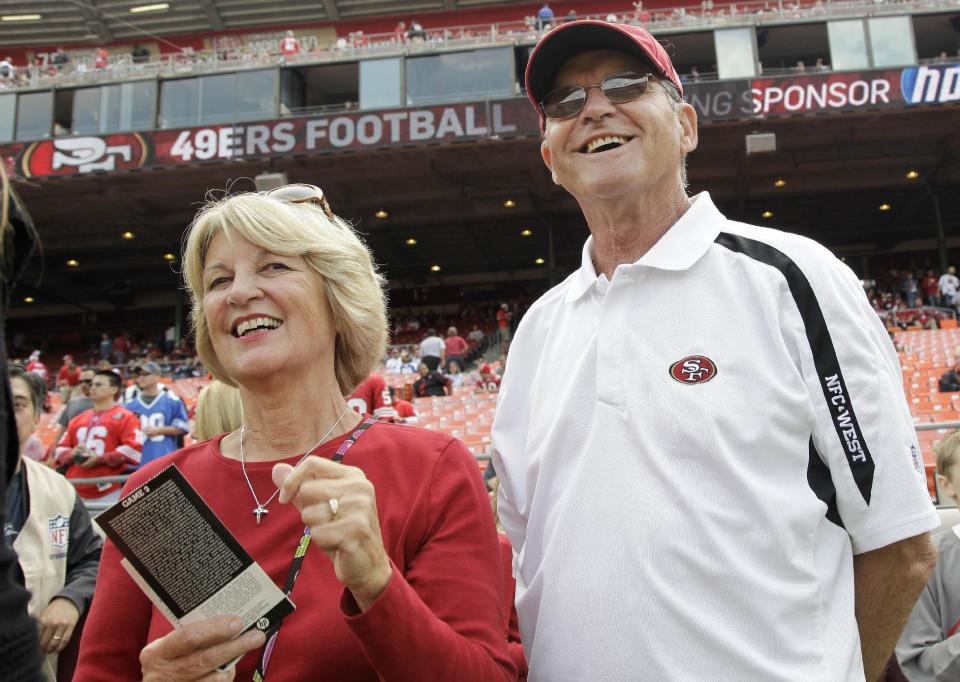 FILE- In this Sept. 11, 2011 file photo, Jackie and Jack Harbaugh, parents of San Francisco 49ers coach Jim Harbaugh and Baltimore Ravens coach John Harbaugh, stand before an NFL football game between the 49ers and the Seattle Seahawks in San Francisco. The entire Harbaugh family already got its Super Bowl victory last Sunday, when each coach did his part to ensure a family reunion in New Orleans next week. The Ravens face off against the 49ers in the first Super Bowl coached by siblings on opposite sidelines. (AP Photo/Paul Sakuma, file)