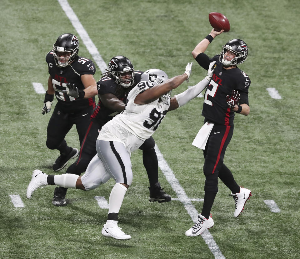 Atlanta Falcons quarterback Matt Ryan throws a touchdown pass to wide receiver Calvin Ridley under pressure from Las Vegas Raiders defensive tackle Johnathan Hankins during the second quarter of an NFL football game on Sunday, Nov 29, 2020, in Atlanta. (Curtis Compton/Atlanta Journal-Constitution via AP)