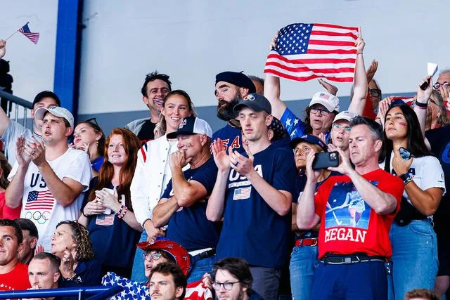 <p>USA Field Hockey</p> Kylie Kelce and Jason Kelce cheer from the stands