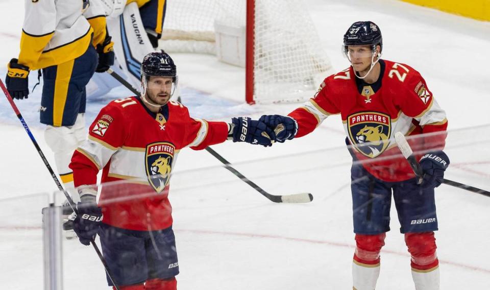 Florida Panthers forward Eetu Luostarinen (27) celebrates with defender Oliver Ekman-Larsson (91) after scoring a goal against the Nashville Predators in the second period of an NHL preseason game at the Amerant Bank Arena on Monday, Sept. 25, 2023, in Sunrise, Fla.