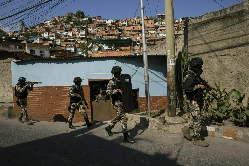 Members the National Police Action Force, or FAES, an elite commando unit created for anti-gang operations, patrol the Antimano neighborhood of Caracas, Venezuela, Tuesday, Jan. 29, 2019. Rights group PROVEA and the crime monitoring group Observatory of Social Conflict say they have recorded 35 deaths during a single week in January, most at night in poor neighborhoods, in addition to eight cases of apparent targeted killings by members of the elite commando unit. (AP Photo/Rodrigo Abd)