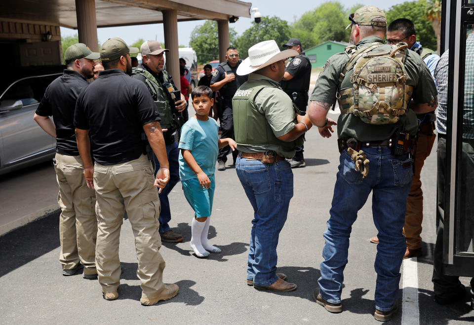 A child gets on a school bus as law enforcement personnel guard the scene of a shooting near Robb Elementary School in Uvalde, Texas, on May 24.<span class="copyright">Marco Bello—Reuters</span>