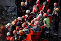 Rescue workers search the site of a collapsed building, after an earthquake in Elazig