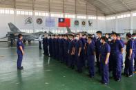 Soldiers gather in front of Indigenous Defense Fighter (IDF) fighter jets at Makung Air Force Base in Taiwan's offshore island of Penghu