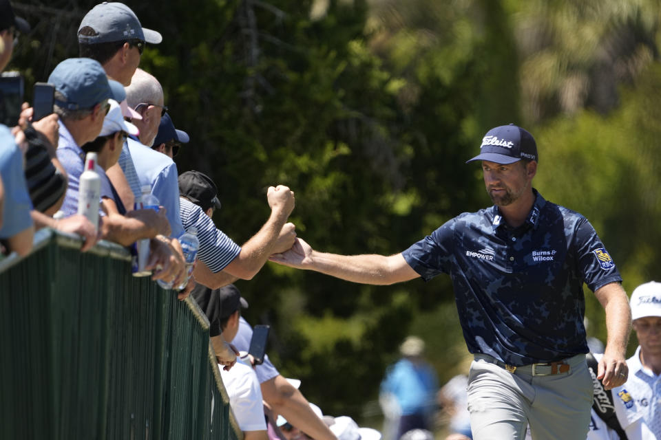Webb Simpson greets fans as the walks to the second fairway during the first round of the PGA Championship golf tournament on the Ocean Course Thursday, May 20, 2021, in Kiawah Island, S.C. (AP Photo/David J. Phillip)