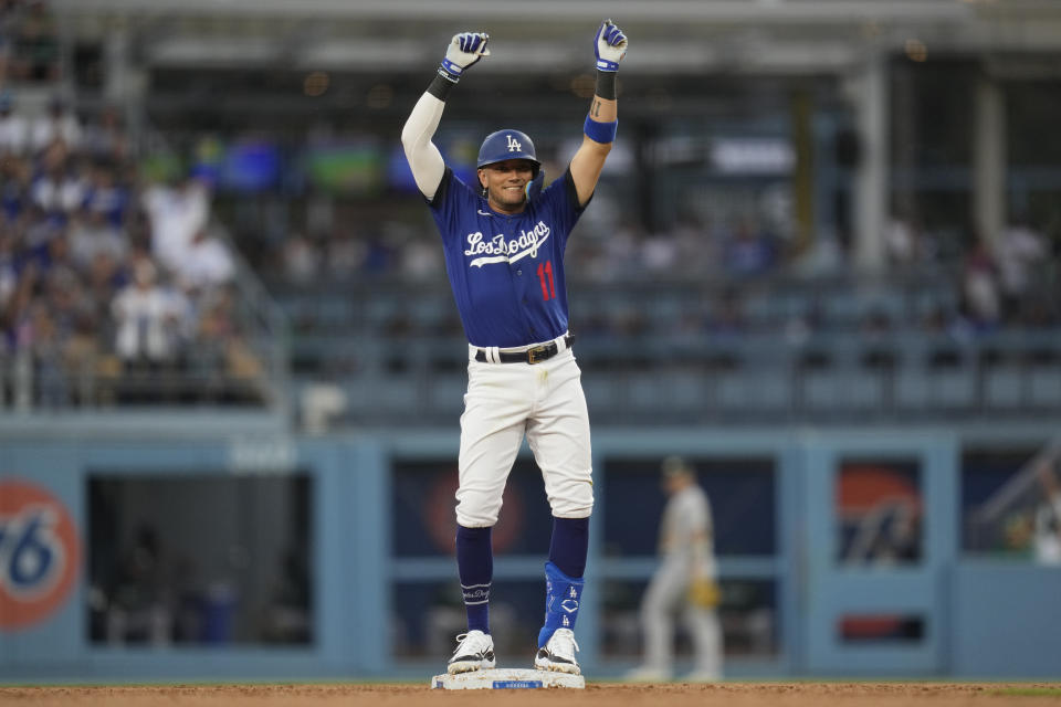 Los Angeles Dodgers' Miguel Rojas (11) celebrates on second base after hitting a double during the second inning of a baseball game against the Oakland Athletics in Los Angeles, Thursday, Aug. 3, 2023. Kiké Hernández scored. (AP Photo/Ashley Landis)