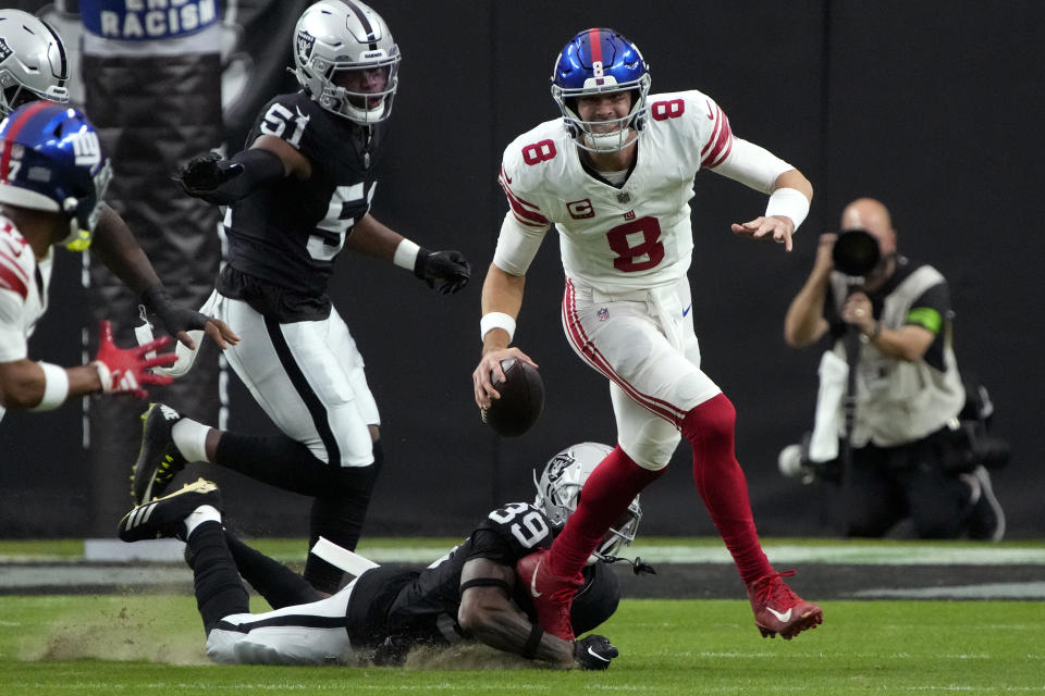 New York Giants quarterback Daniel Jones (8) scrambles as Las Vegas Raiders cornerback Nate Hobbs (39) pursues during the first half of an NFL football game, Sunday, Nov. 5, 2023, in Las Vegas. (AP Photo/Rick Scuteri)