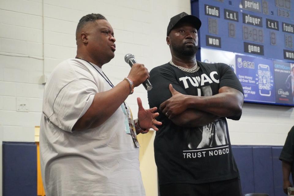 Pastor Karl "The Rev." Anderson, left, introduces former gangsta rapper Project Pat, right, as the keynote speaker at the 25th annual Stop the Violence Back to School Rally on Saturday at Santa Fe College.