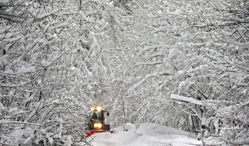 A road in a forest is cleaned from snow in Schongau, southern Germany, Thursday, Jan. 10, 2019 after Austria and southern Germany were hit by heavy snowfall. (Karl-Josef Hildenbrand/dpa via AP)