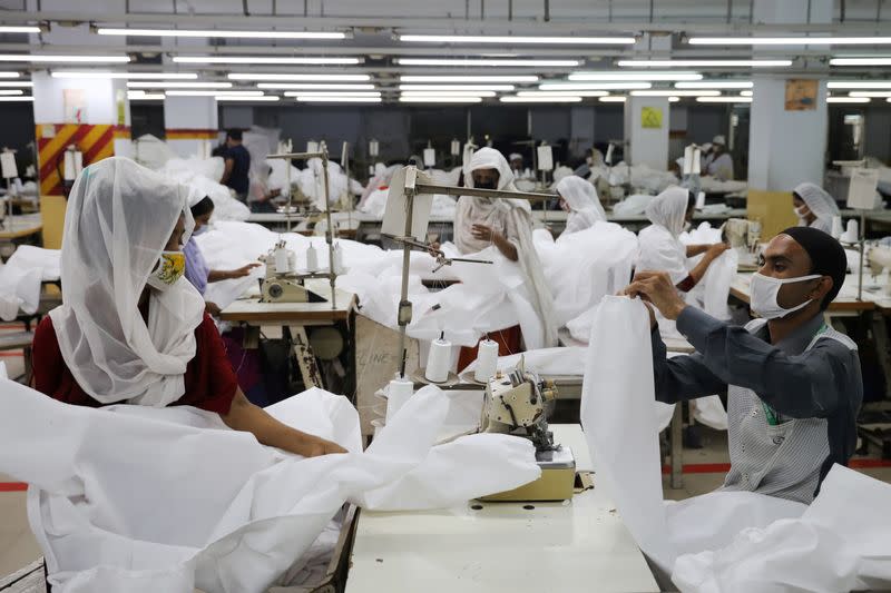 Bangladeshi garment workers make protective suit at a factory amid concerns over the spread of the coronavirus disease (COVID-19) in Dhaka