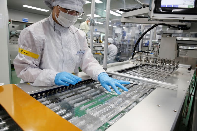 An employee works at a low dead space (LDS) syringe factory in Gunsan