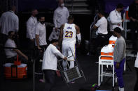 Los Angeles Lakers forward LeBron James walks to the locker room after kicking a chair following an injury during the first half of an NBA basketball game against the Atlanta Hawks Saturday, March 20, 2021, in Los Angeles. (AP Photo/Marcio Jose Sanchez)