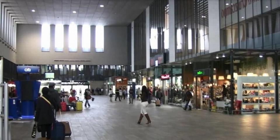 Passengers browse retail shops and restaurants that lease space on the upper level of the Santa Justa high-speed train station in Seville, Spain. Passenger boarding platforms are downstairs.