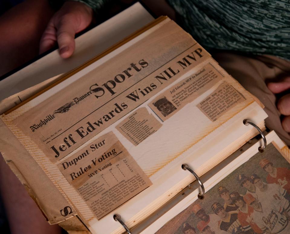 Jeff Edwards, looks through a photo album of old newspaper clippings and other items from when he played baseball at his home in Mt. Juliet, Tenn., Thursday, March 28, 2024.